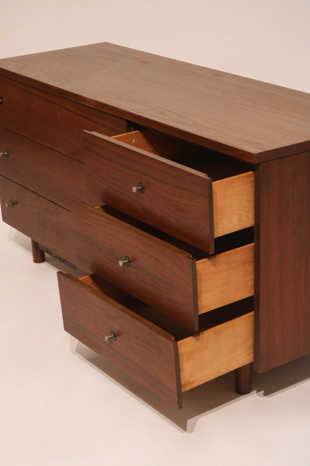 Underside of dresser revealing the structure and partially missing bottom component