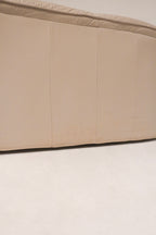 Underneath view of Salotti Natuzzi couch structure showing frame and leather wrapping