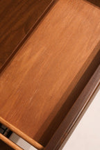 Lower corner detail of dresser with visible base structure and minor surface mark