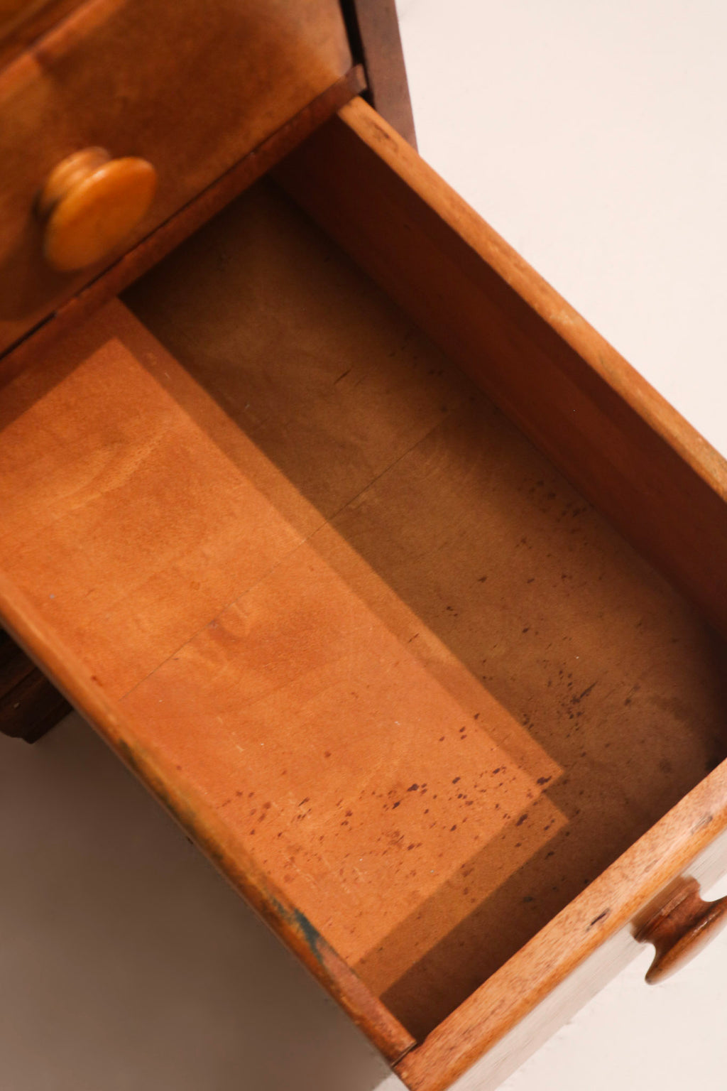 Interior view of drawer baseboard with smooth maple surface and wood coloring