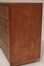 Detail of drawer fronts on solid wood dresser chest, stained walnut finish with visible grain and consistent sanded surface texture