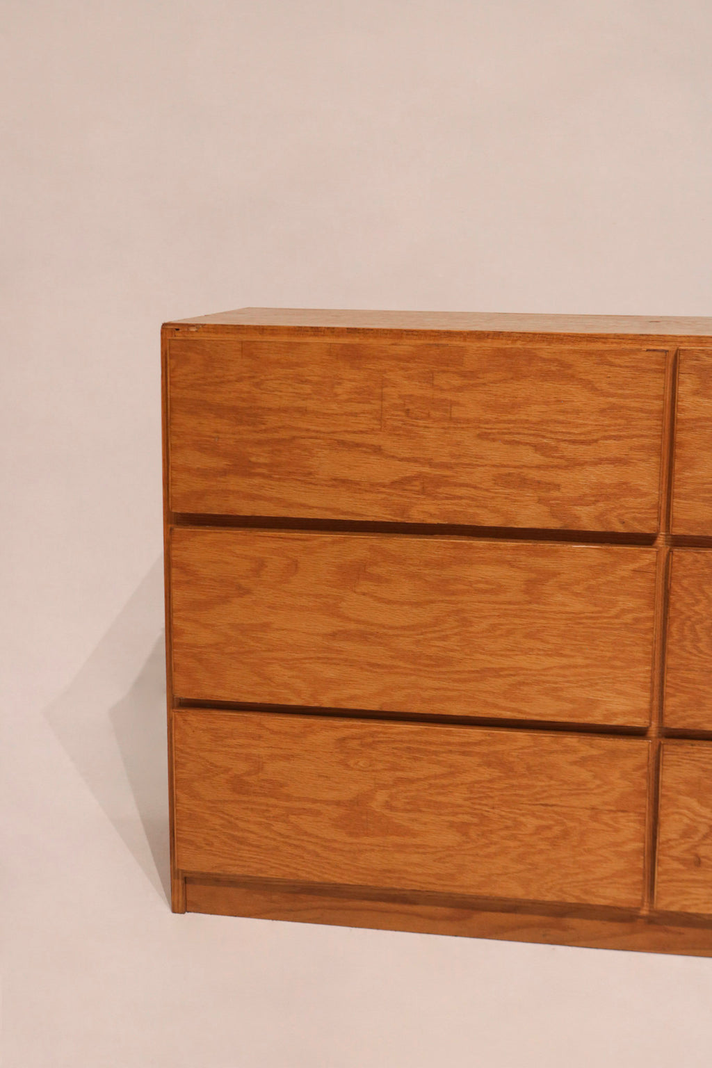 Top surface of oak dresser with light scratches and worn finish for rustic appeal