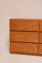 Top surface of oak dresser with light scratches and worn finish for rustic appeal