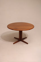 Full view of vintage Danish modern teak wood dining table with round shape and warm wood finish
