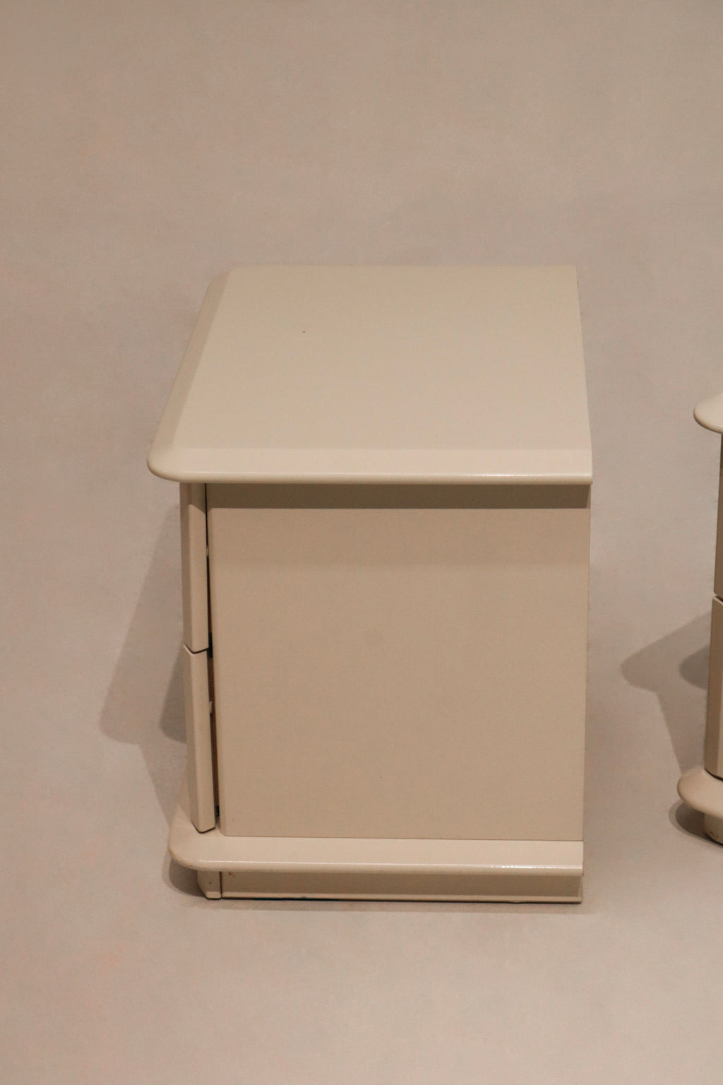 Detailed shot of nightstand legs showcasing clean vintage lines and lacquered finish