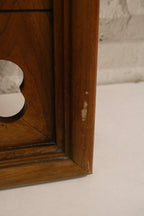 Surface texture of oak wood frame showing aged varnish, warm grain, patina streaks and minor wear typical of vintage pieces.