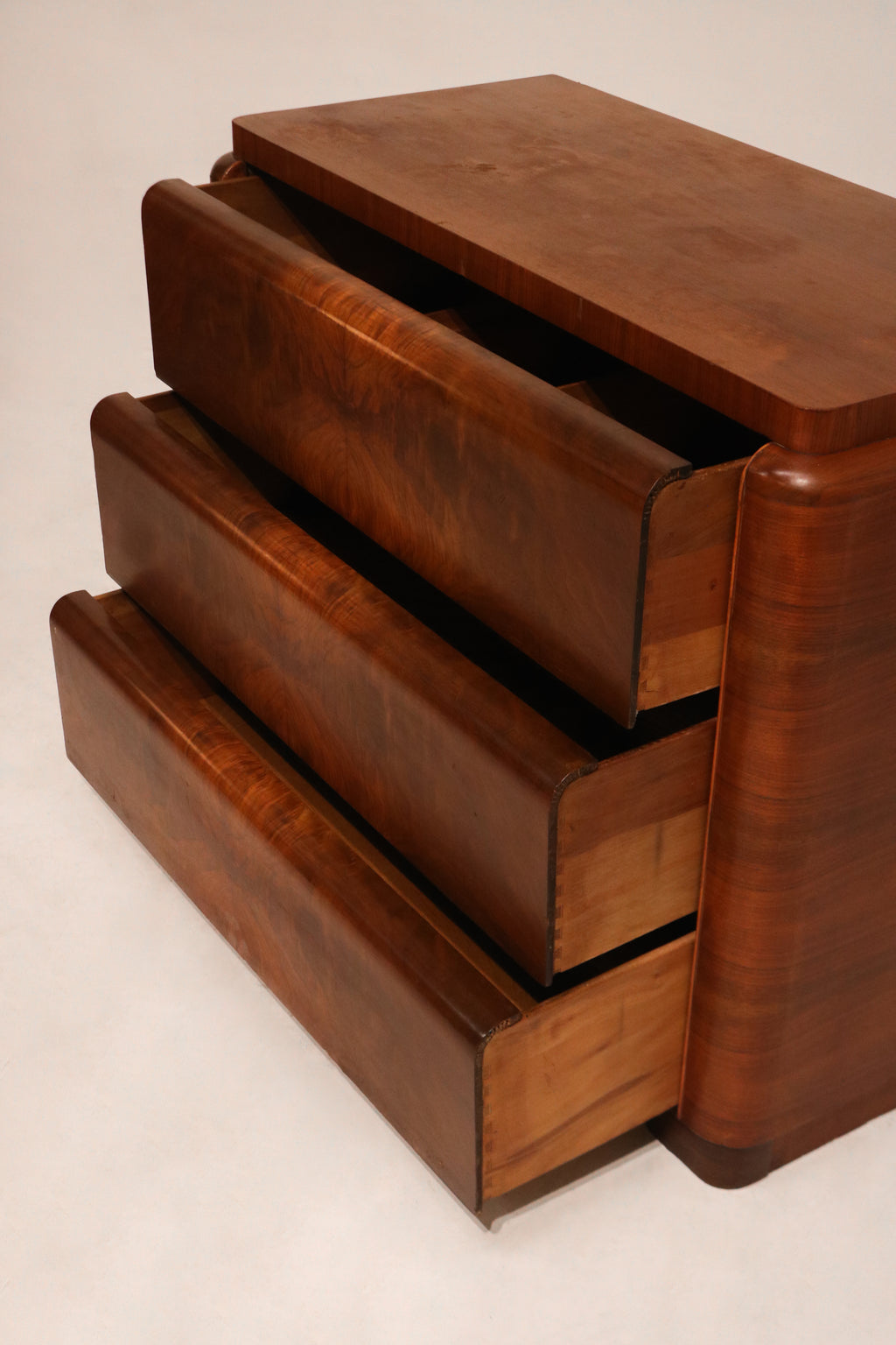 Right side panel of the dresser showcasing the continuous burlwood veneer grain pattern