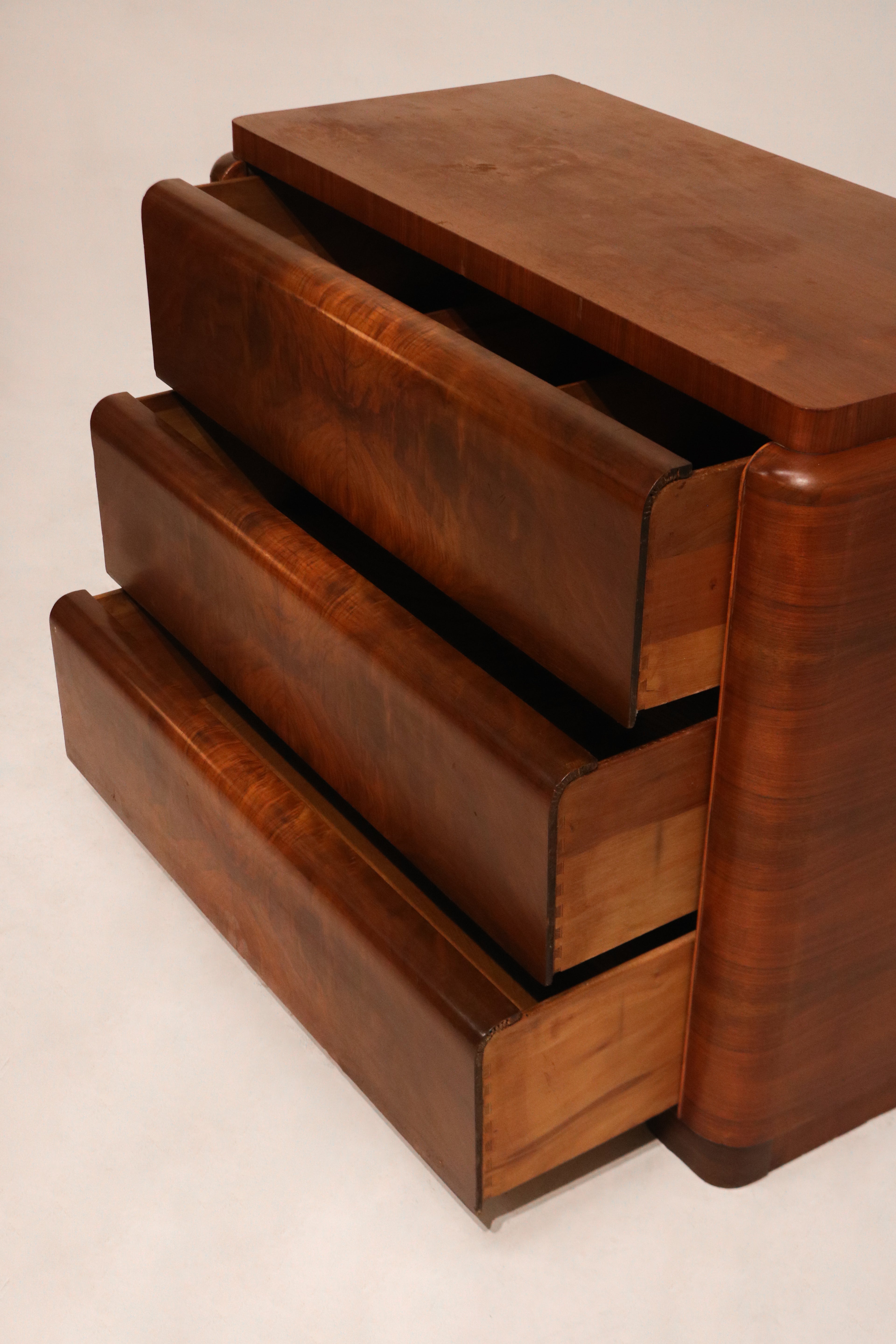 Right side panel of the dresser showcasing the continuous burlwood veneer grain pattern