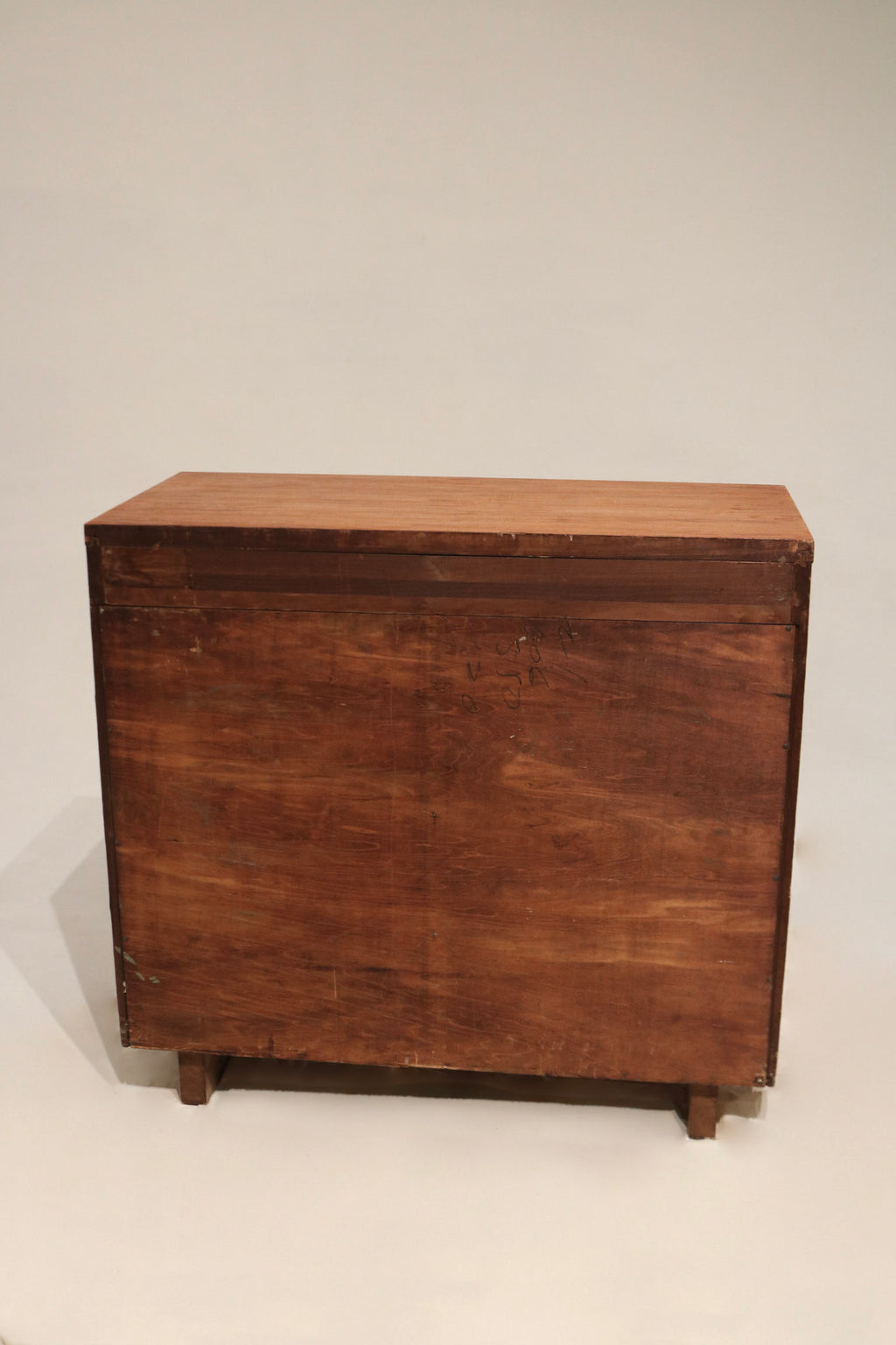 Photo of hardware area and drawer pull attachment on vintage solid wood dresser, stained walnut surface with visible fastening points