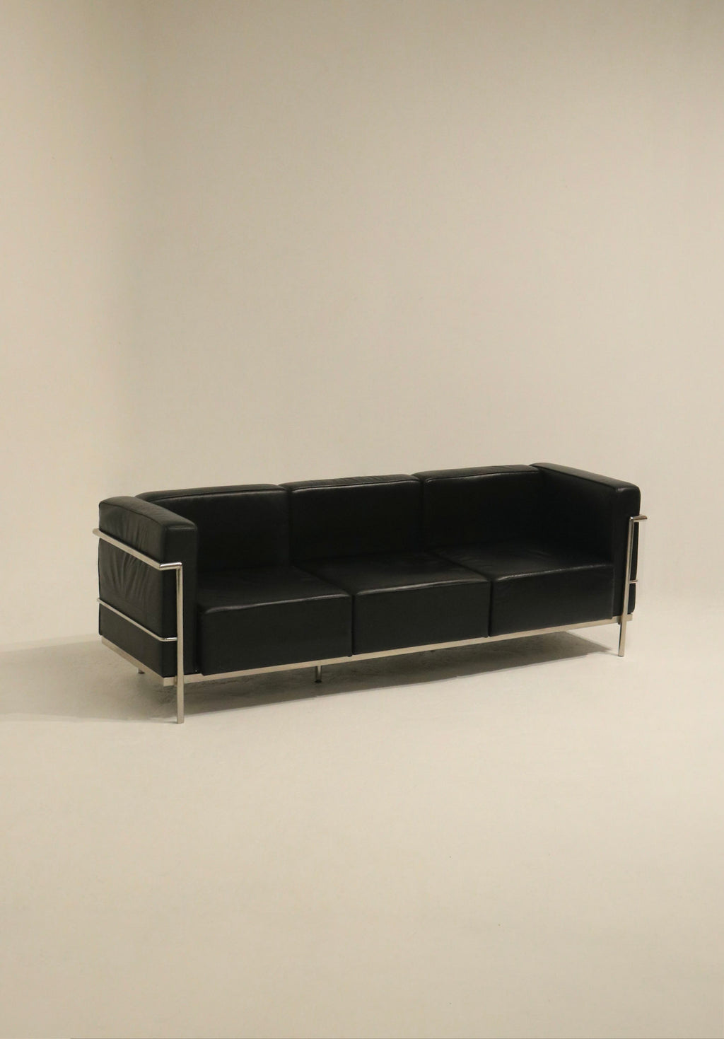 Le Corbusier style chair with chrome frame and faux leather upholstery