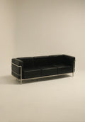 Le Corbusier style chair with chrome frame and faux leather upholstery
