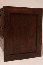 Detailed view of drawer front showing wooden pull handles and seamless craftsmanship