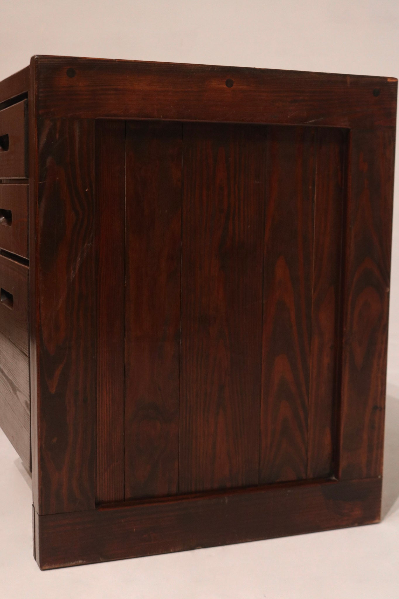 Detailed view of drawer front showing wooden pull handles and seamless craftsmanship