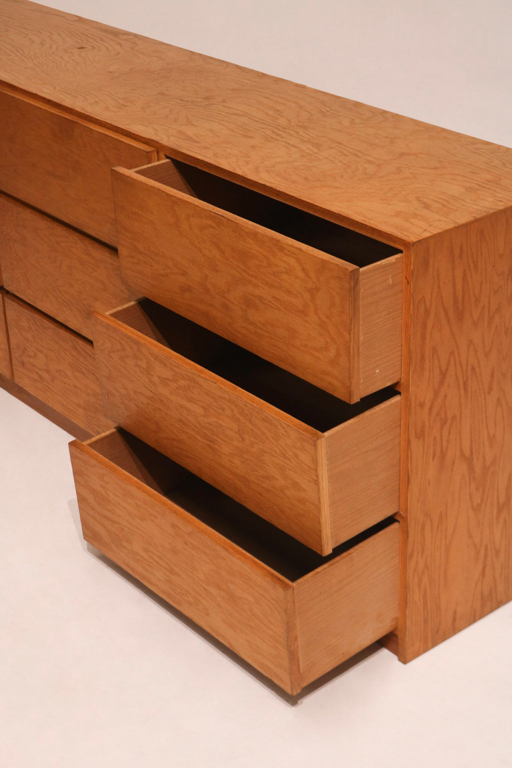 View of fully opened drawers displaying plywood inner material and storage depth