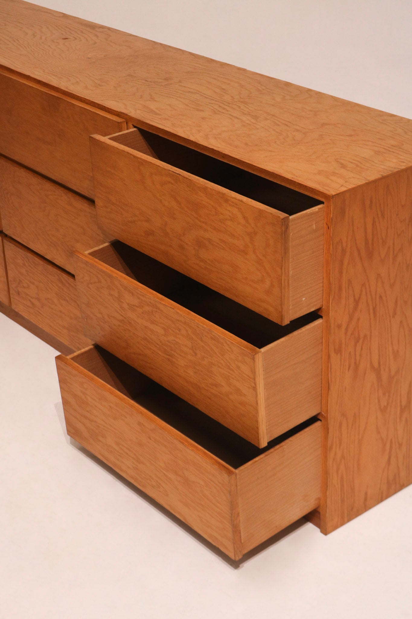 View of fully opened drawers displaying plywood inner material and storage depth