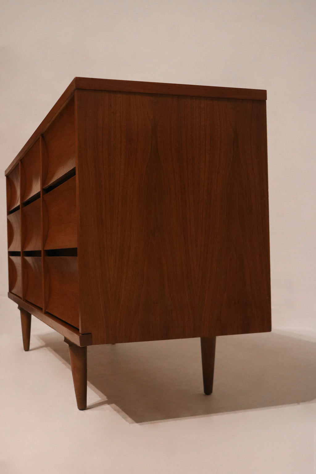 Surface wear marks on top veneer of dresser captured in close photographic detail