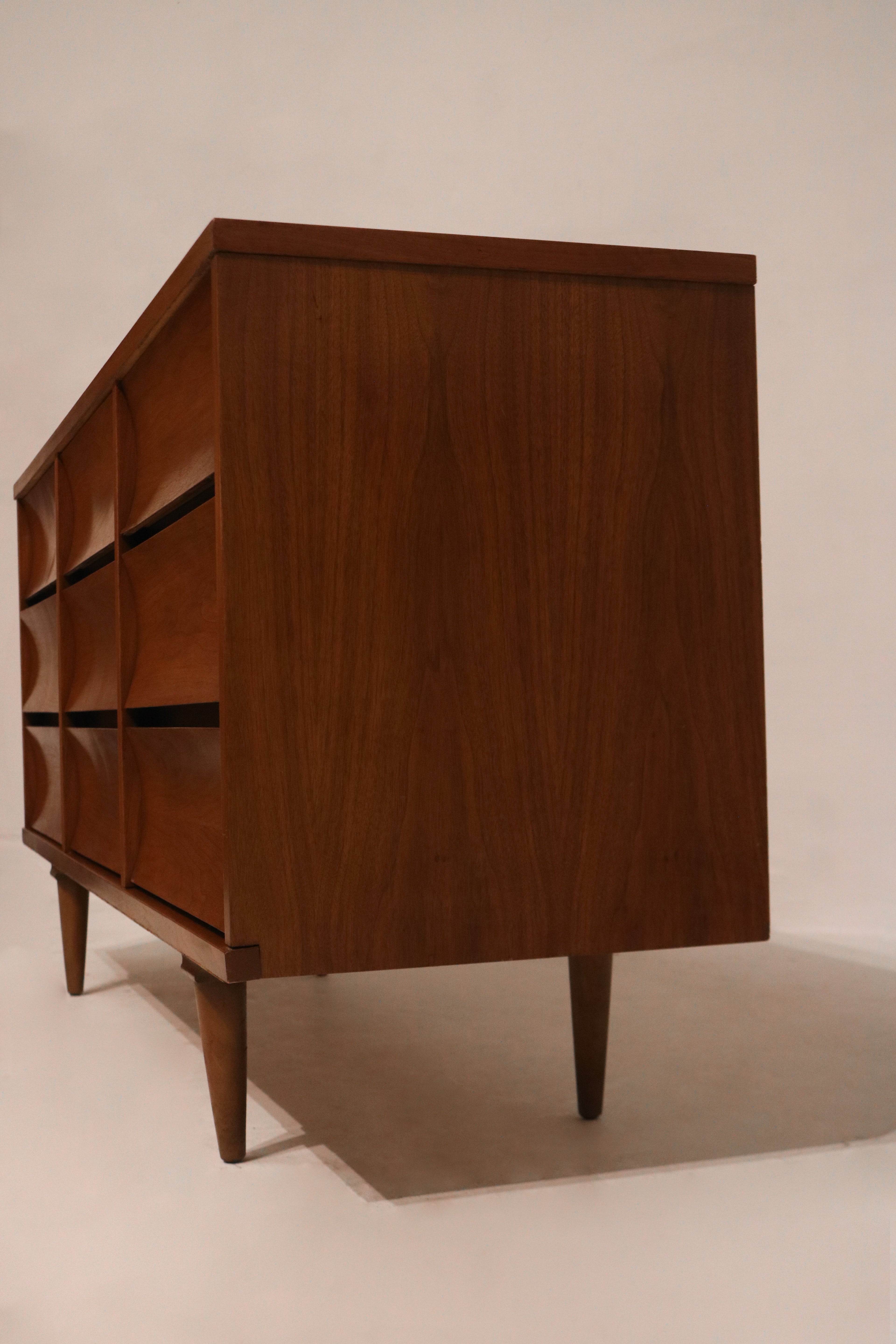 Surface wear marks on top veneer of dresser captured in close photographic detail