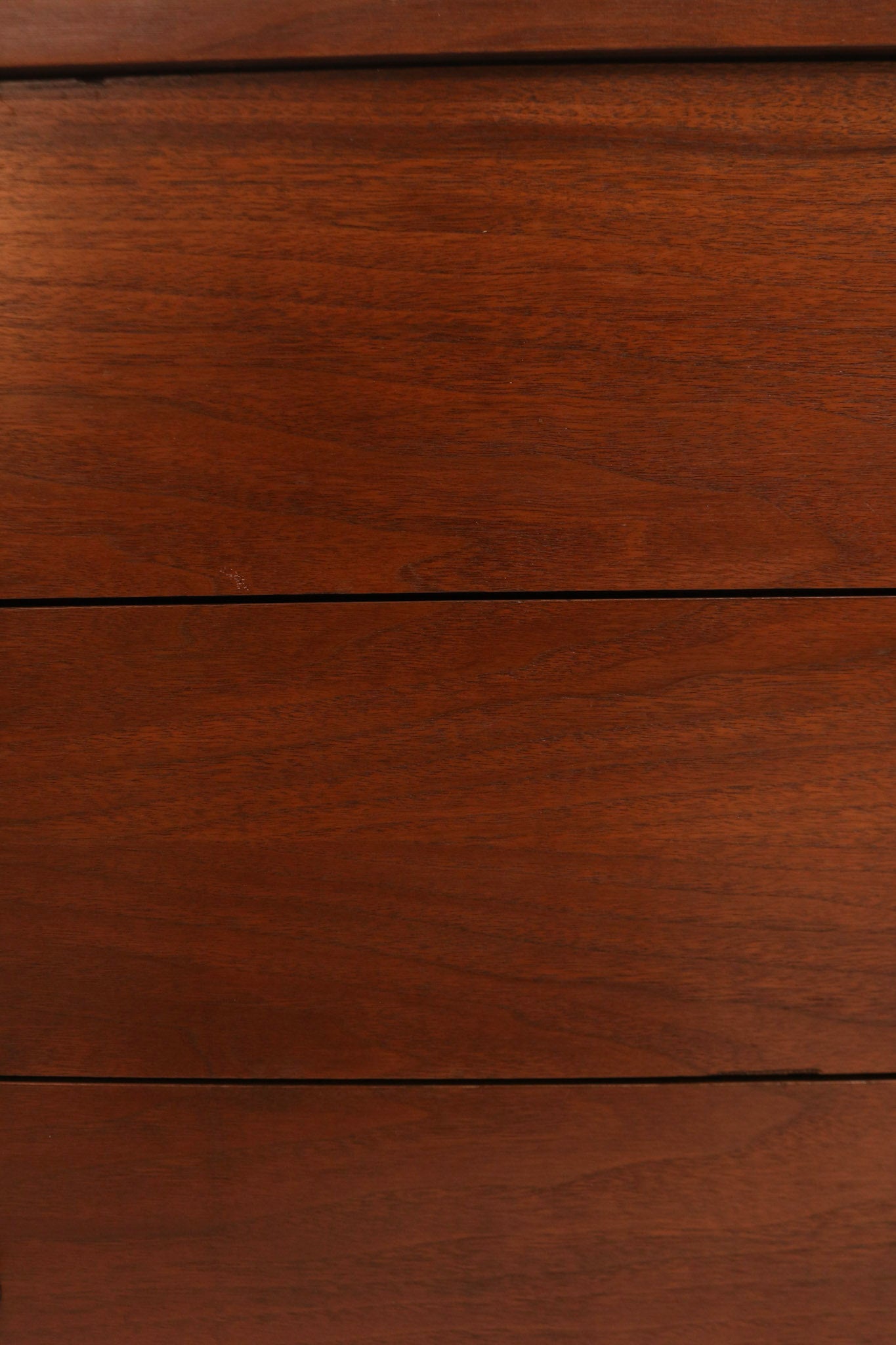View of dresser top surface showing partial veneer with smooth, glossy finish