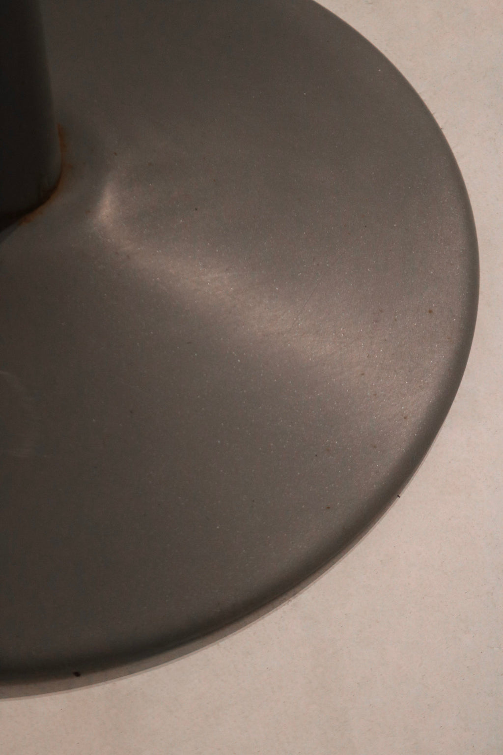 Underside detail of table showing chrome hardware and industrial-grade construction