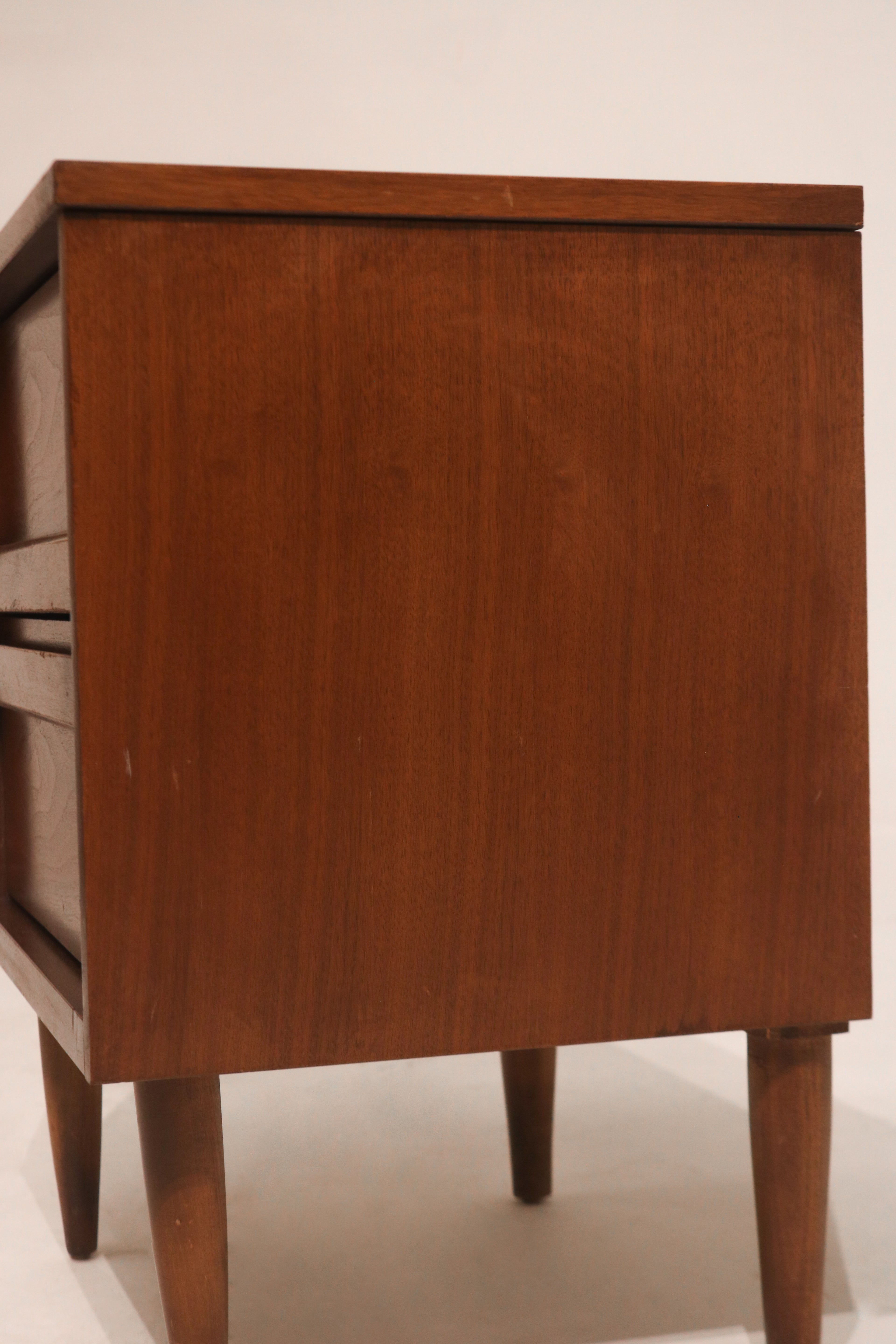 Detailed shot of metal drawer handles with retro vintage design on wood surface