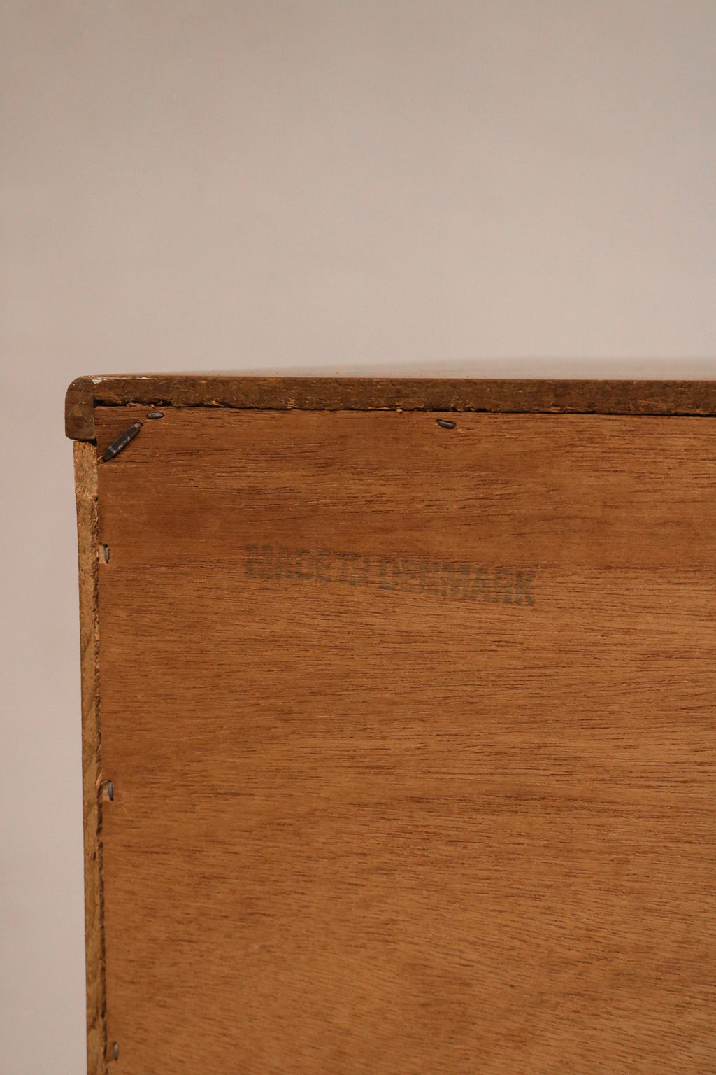 Close-up of teak wood grain texture on drawer fronts of vintage Danish MCM dresser