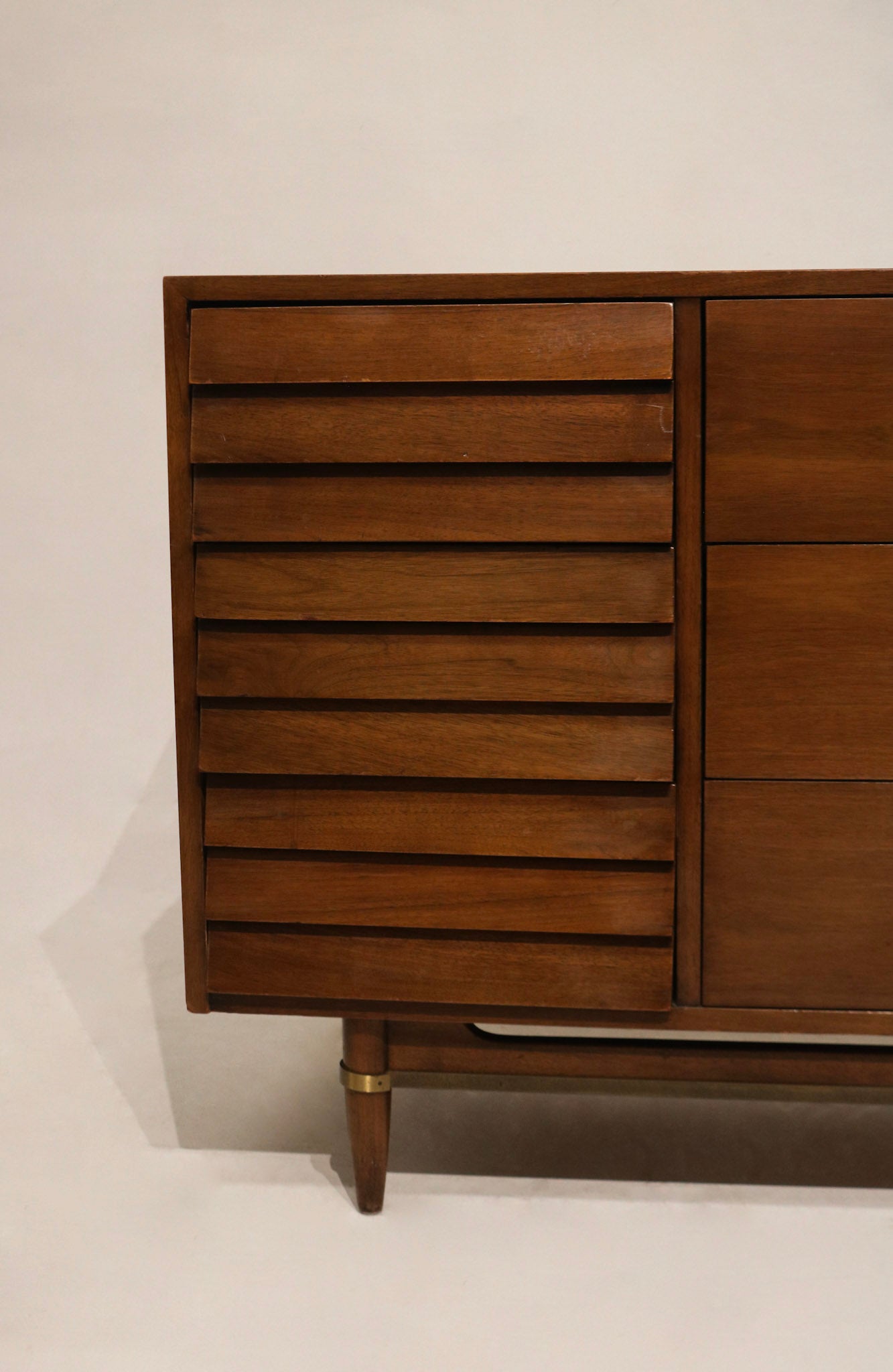 Angled room shot emphasizing storage capacity, multiple deep drawers and classic Merton Gershun proportions