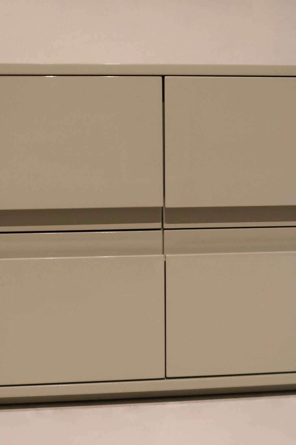 Angle view of dresser’s right side with clean lacquered wood and sleek structure