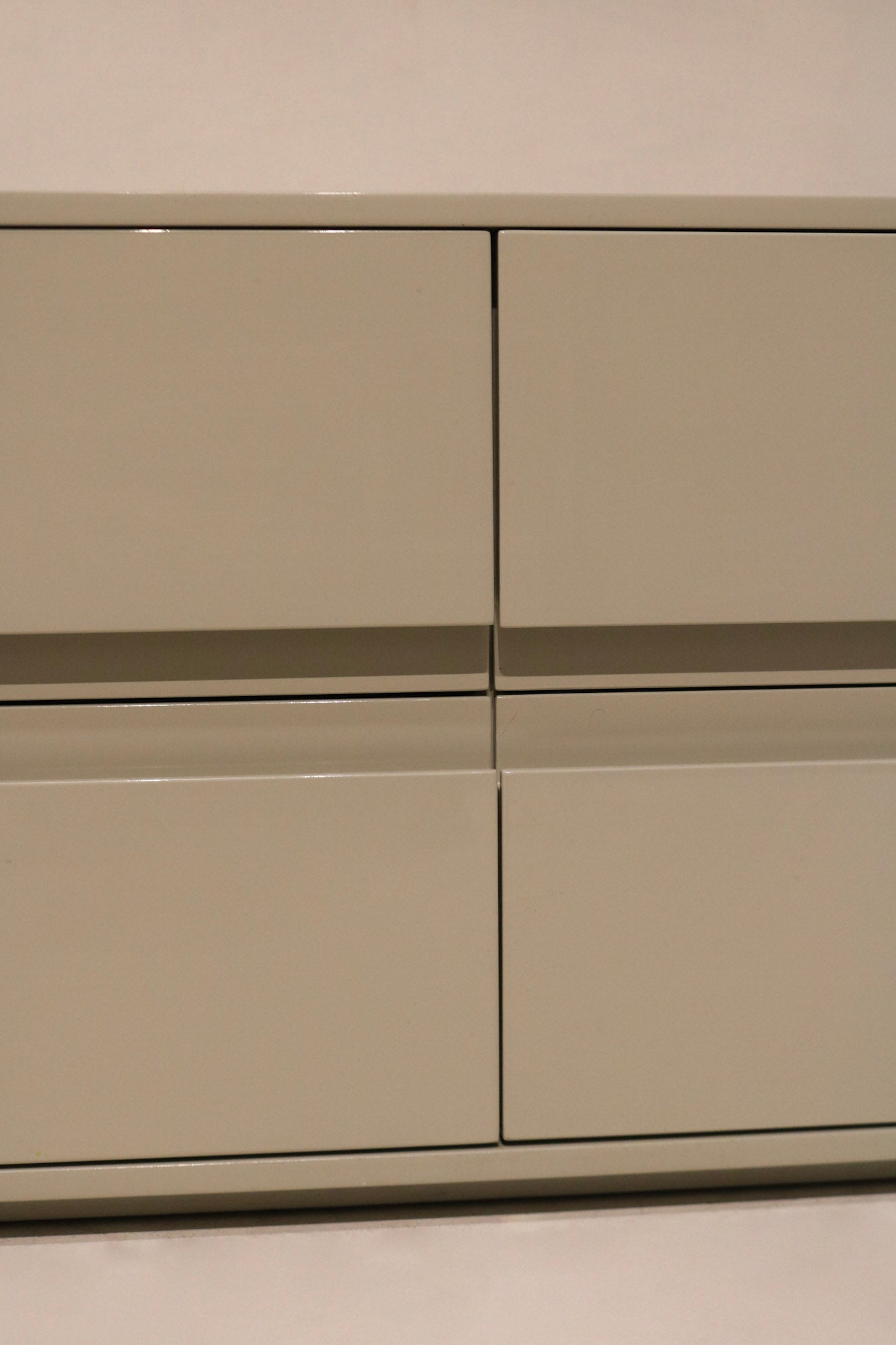 Angle view of dresser’s right side with clean lacquered wood and sleek structure