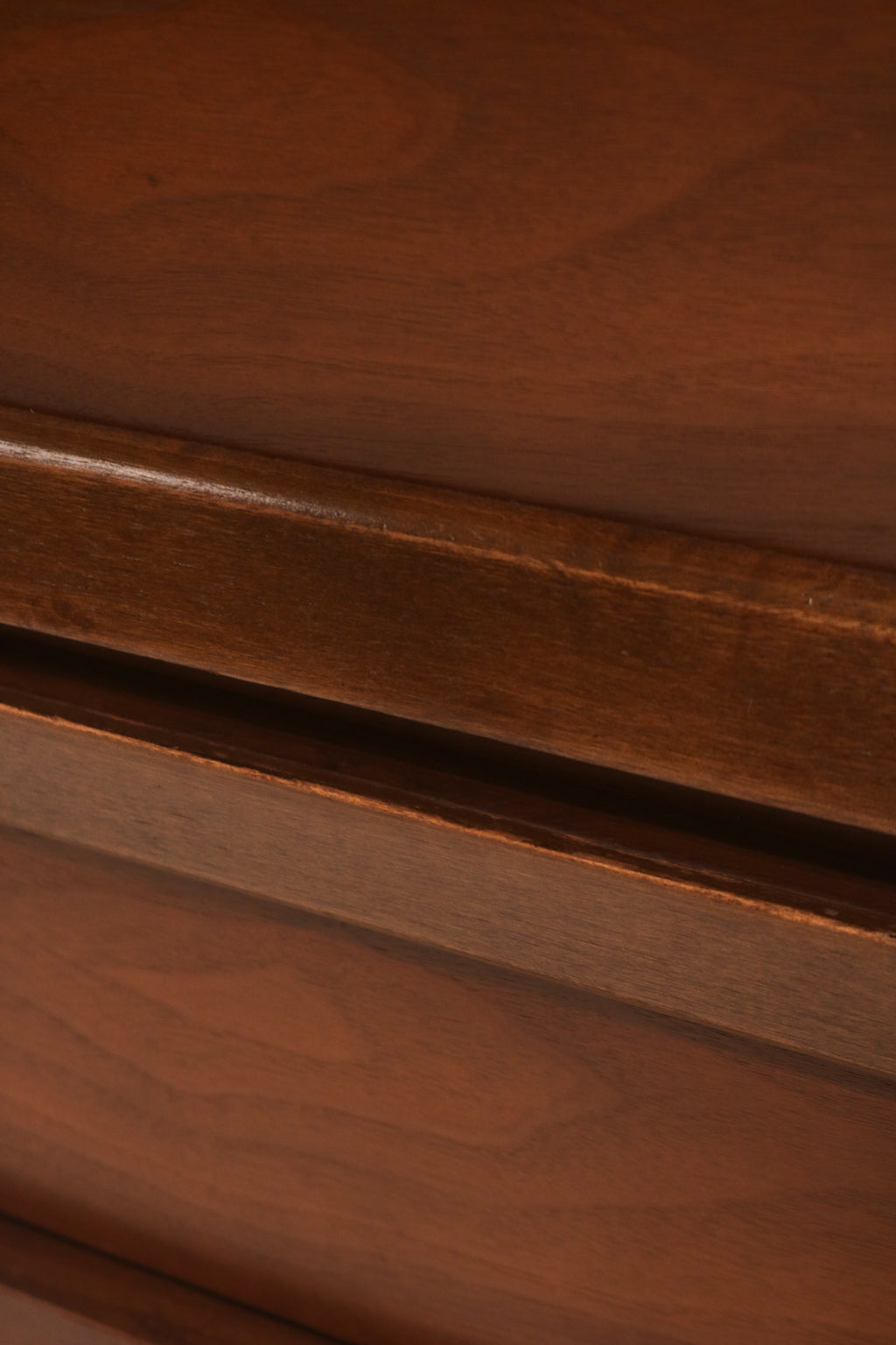 Close-up of walnut wood grain texture on vintage nightstand surface with veneer top