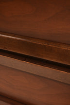 Close-up of walnut wood grain texture on vintage nightstand surface with veneer top
