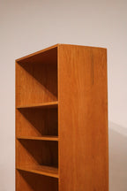 Zoomed view of shelf brackets and grooves inside the oak bookcase showing adjustability