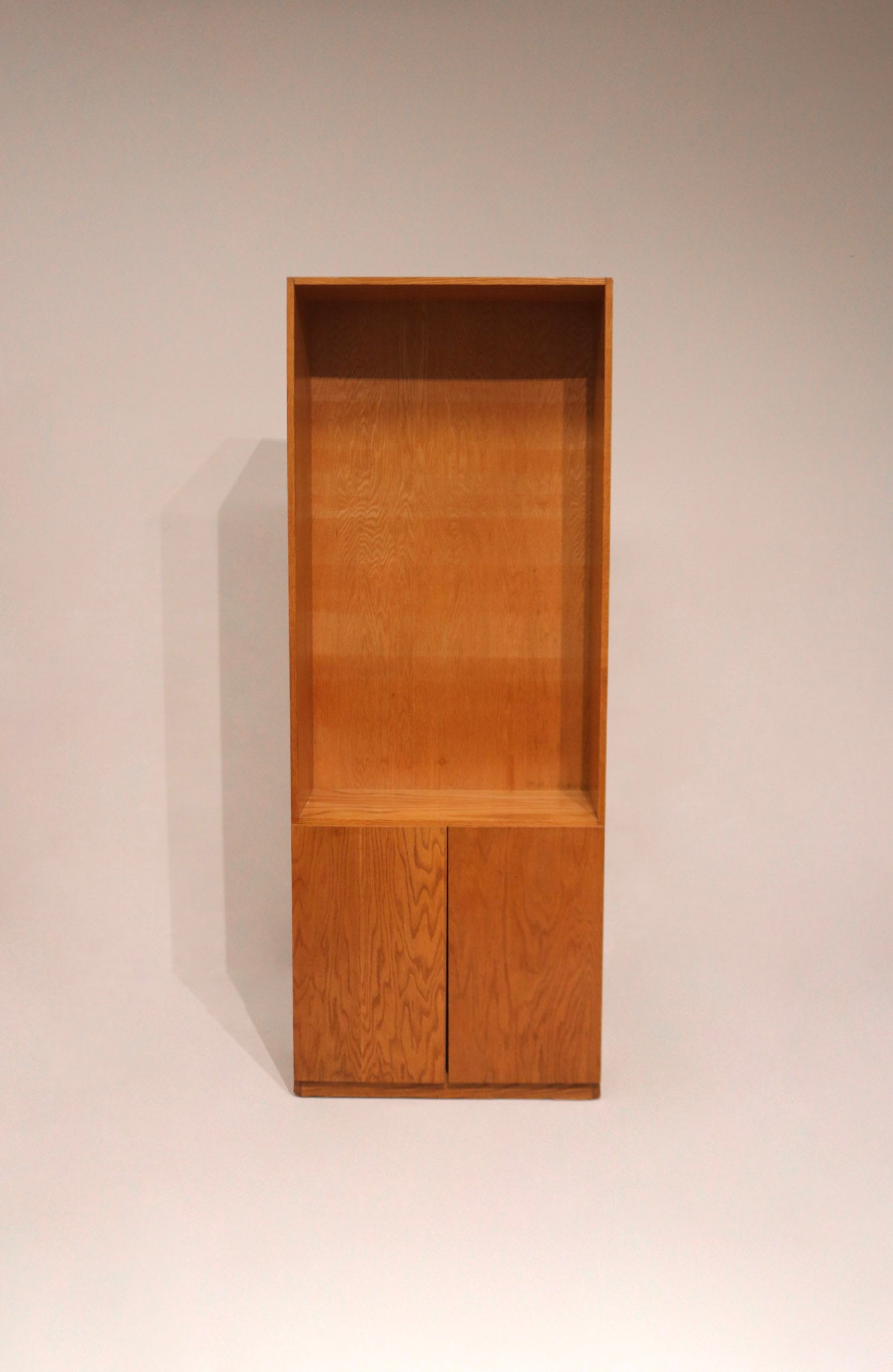 Image showing slight wear at bottom edge of oak bookcase with warm natural finish