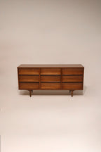 Full view of Mid Century Modern walnut wood dresser with 9 drawers by Johnson Carper in vintage NYC style