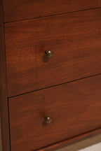 Side profile of the small dresser highlighting mid-century legs and compact shape