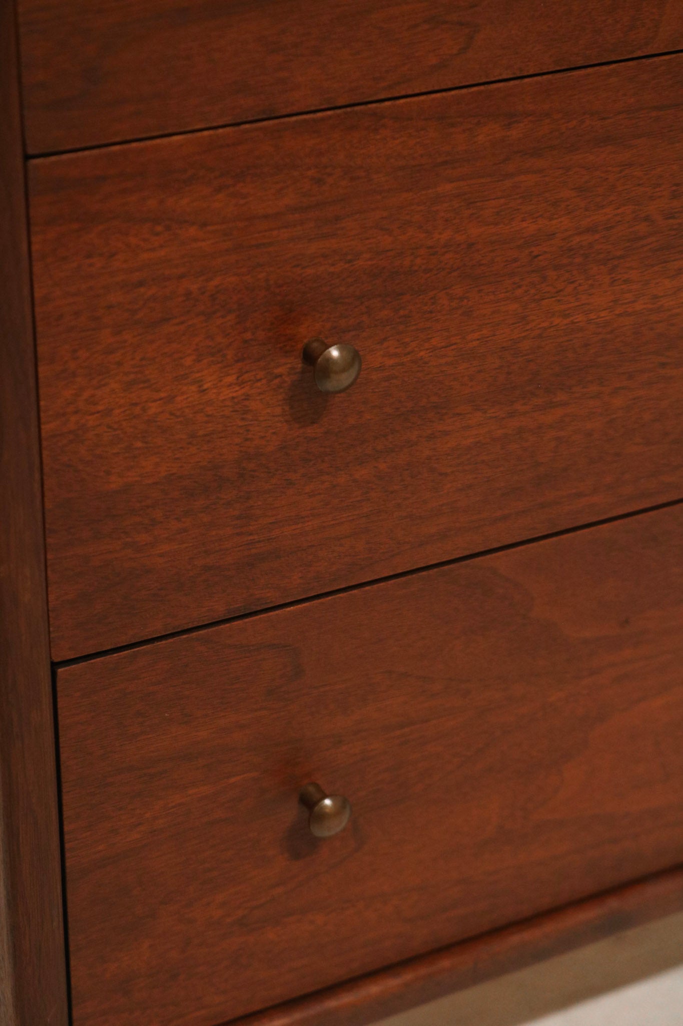 Side profile of the small dresser highlighting mid-century legs and compact shape