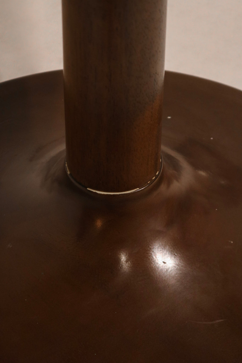Angle view of dining table showing glossy wood texture and stylish round design