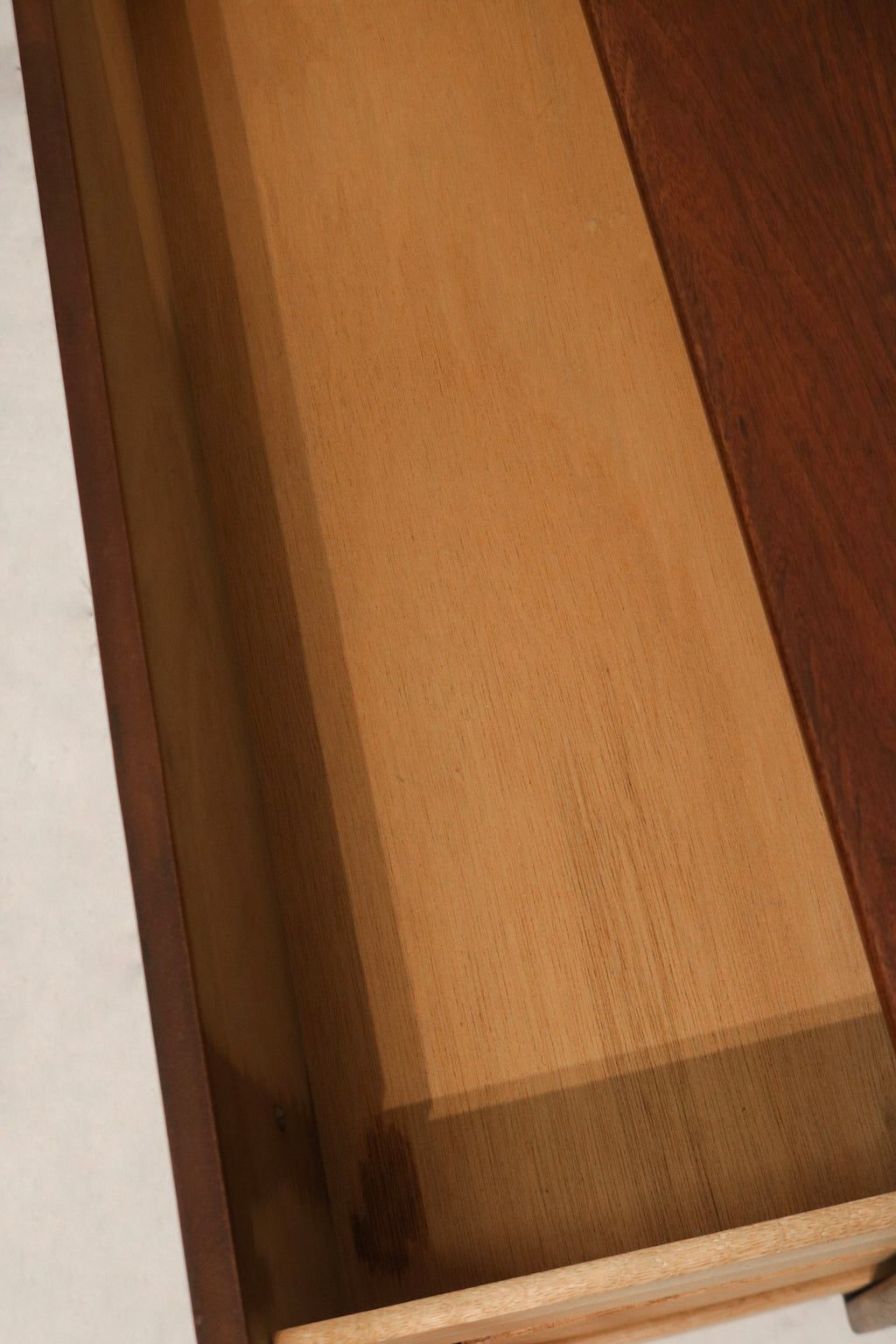 Close-up of right side with two tiny nicks on walnut finish, minimal wear visible