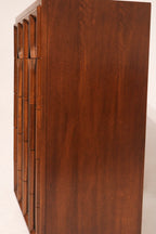 Image focusing on base and leg design of Thomasville Highboy Dresser with a minimalist vintage look