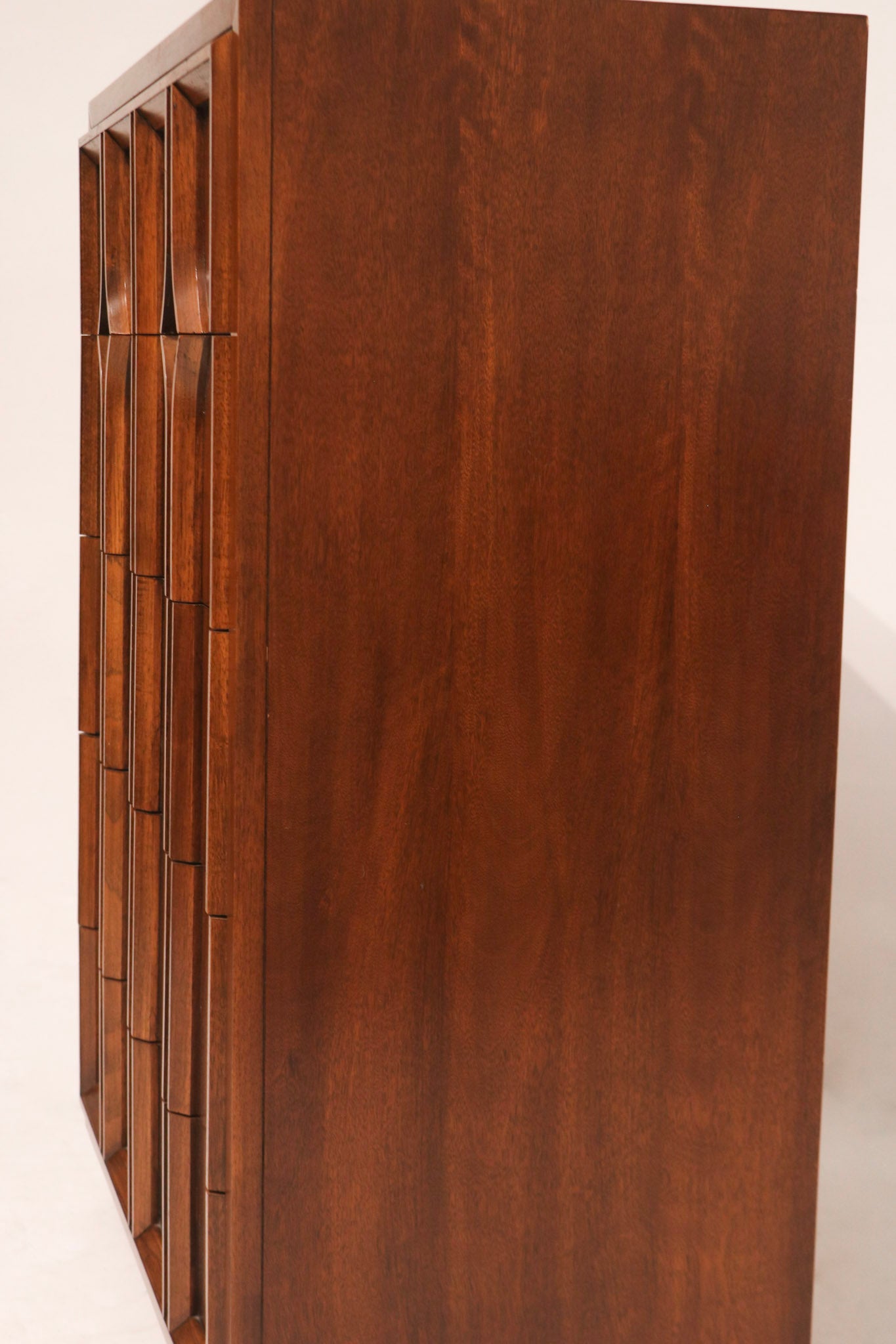 Image focusing on base and leg design of Thomasville Highboy Dresser with a minimalist vintage look