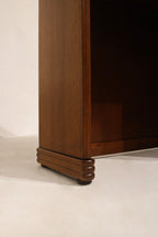 Detail: hinge and folding mechanism close-up on walnut wood desk, metal hardware and functional movement