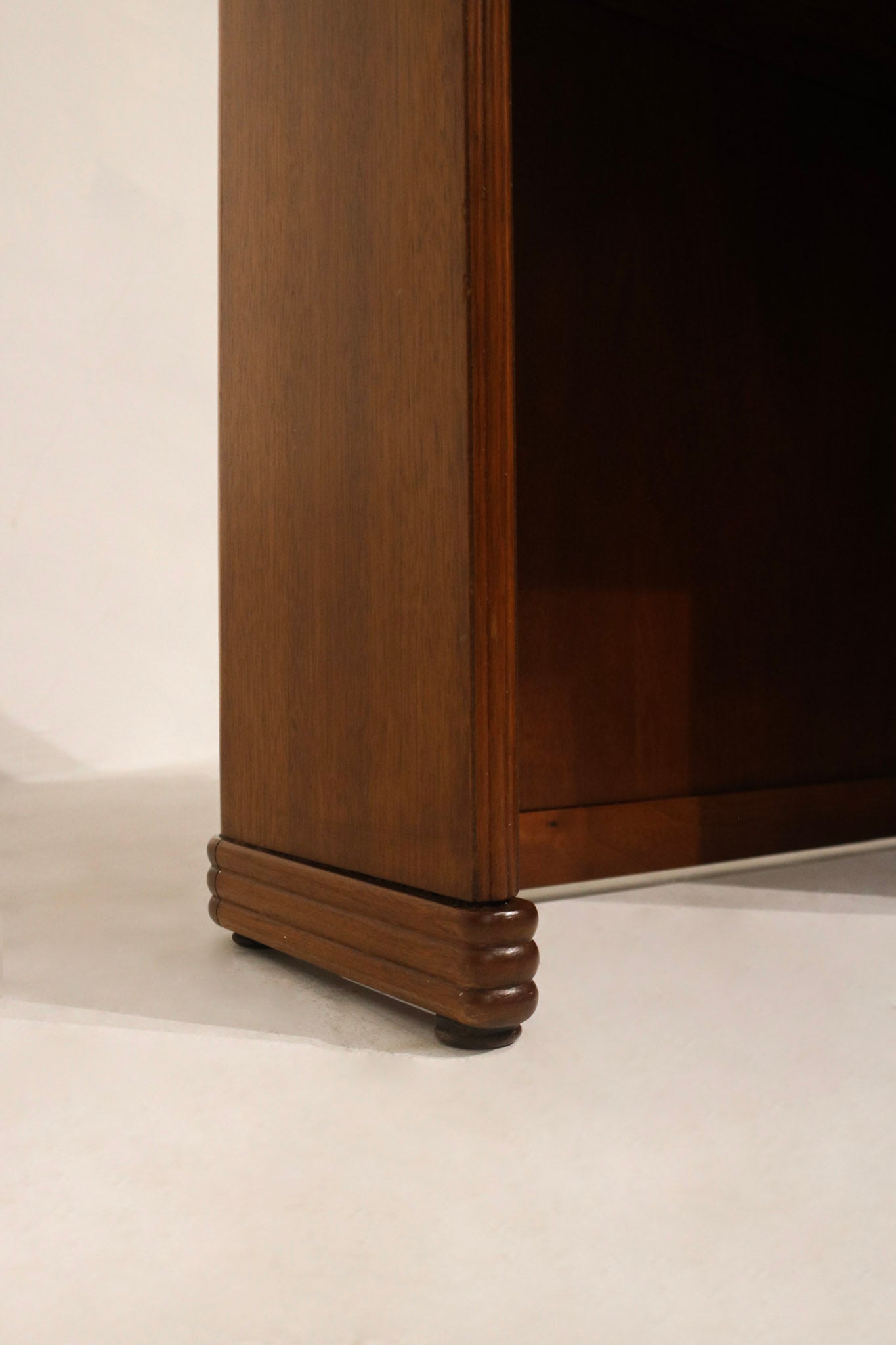 Detail: hinge and folding mechanism close-up on walnut wood desk, metal hardware and functional movement