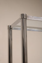 Detailed view of chrome steel frame and glass construction on Vintage Mcm Bookcase