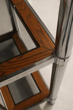 Bottom shelf detail showing sturdy wood panel with chrome leg supports
