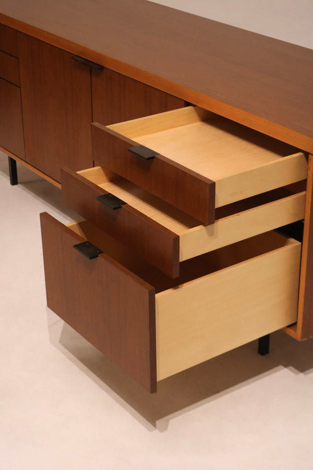 Close-up of walnut wood surface showing natural grain and smooth mid-century finish