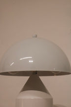 Bottom view of lamp base structure in white coated metal with protective pads