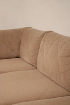 Corner connection detail showing modular frame joint and fabric-wrapped frame of Mcm sectional sofa, demonstrating solid vintage construction