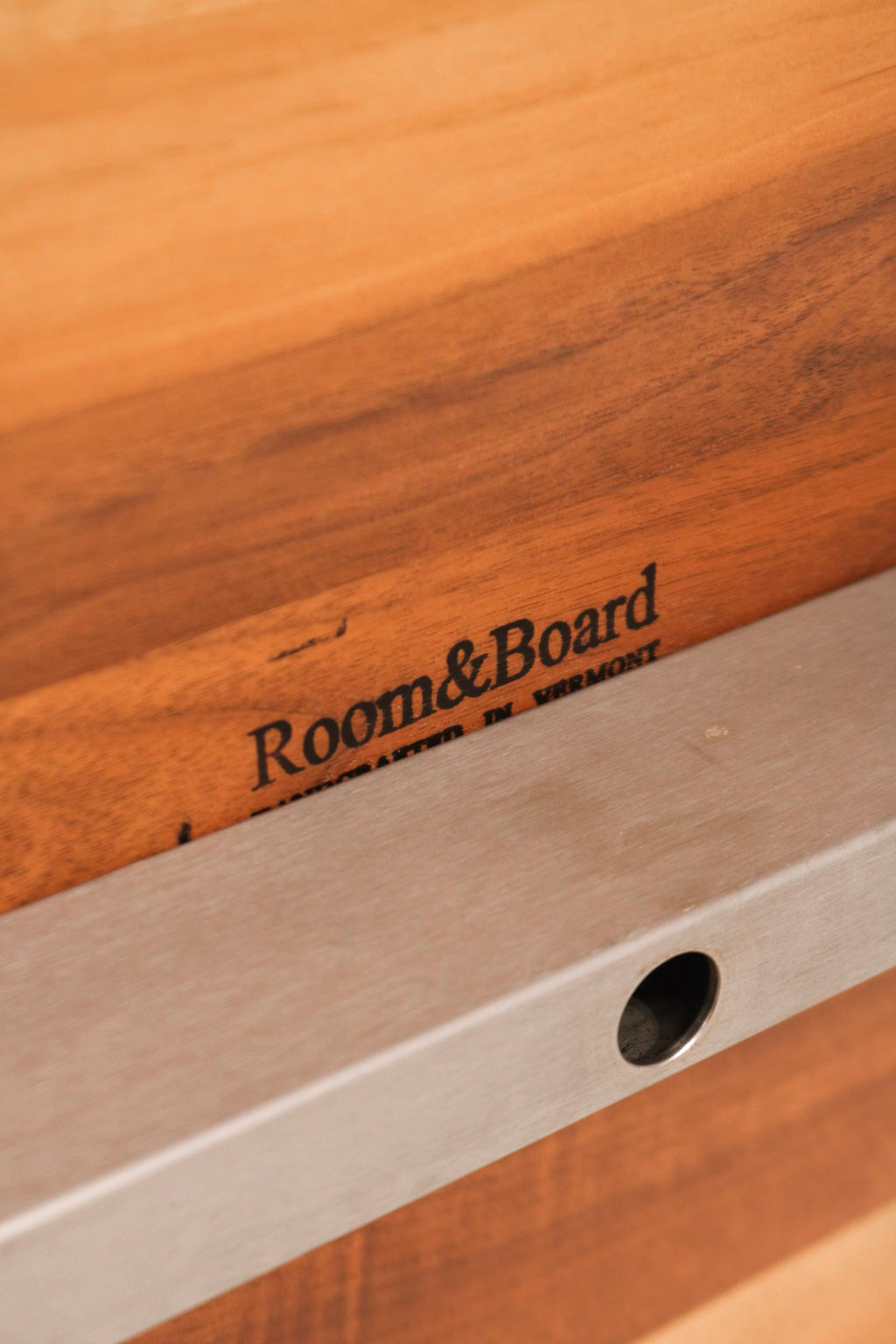 Close-up of solid wood tabletop with visible natural grain and minor surface marks