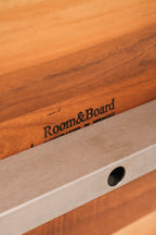 Close-up of solid wood tabletop with visible natural grain and minor surface marks