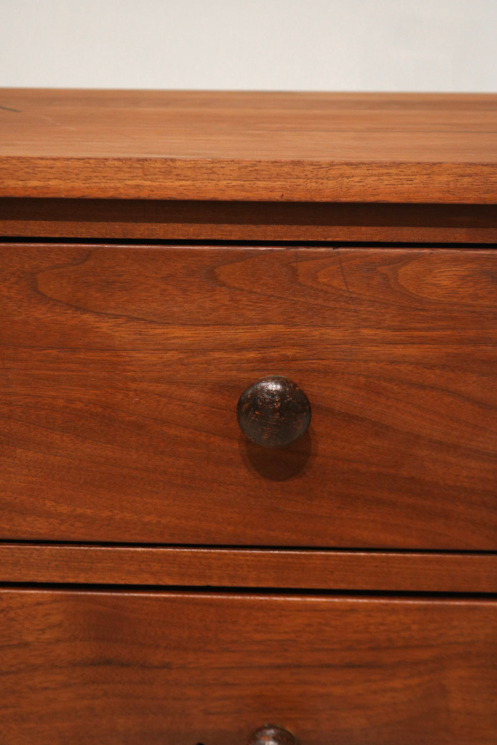 Detail view of bottom drawer with two small imperfections in the wood