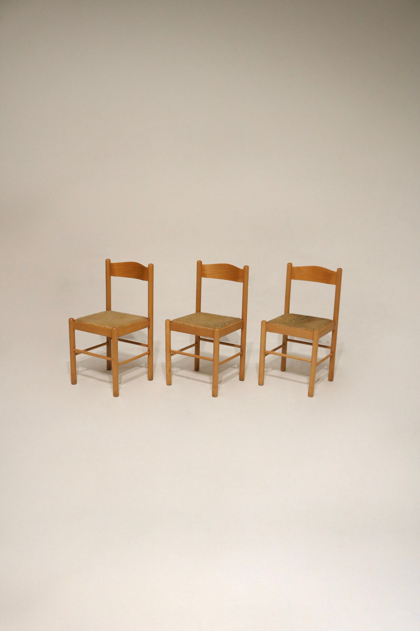 Rustic chalet-style wooden chair with woven rush seat